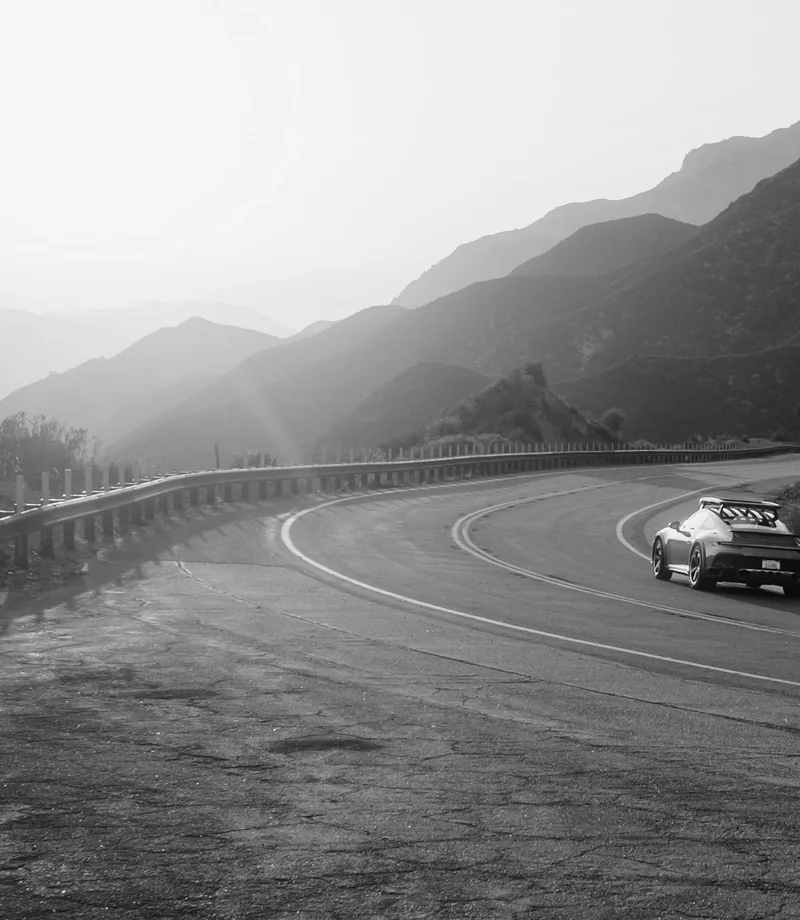 A quiet mountain road winding toward distant peaks